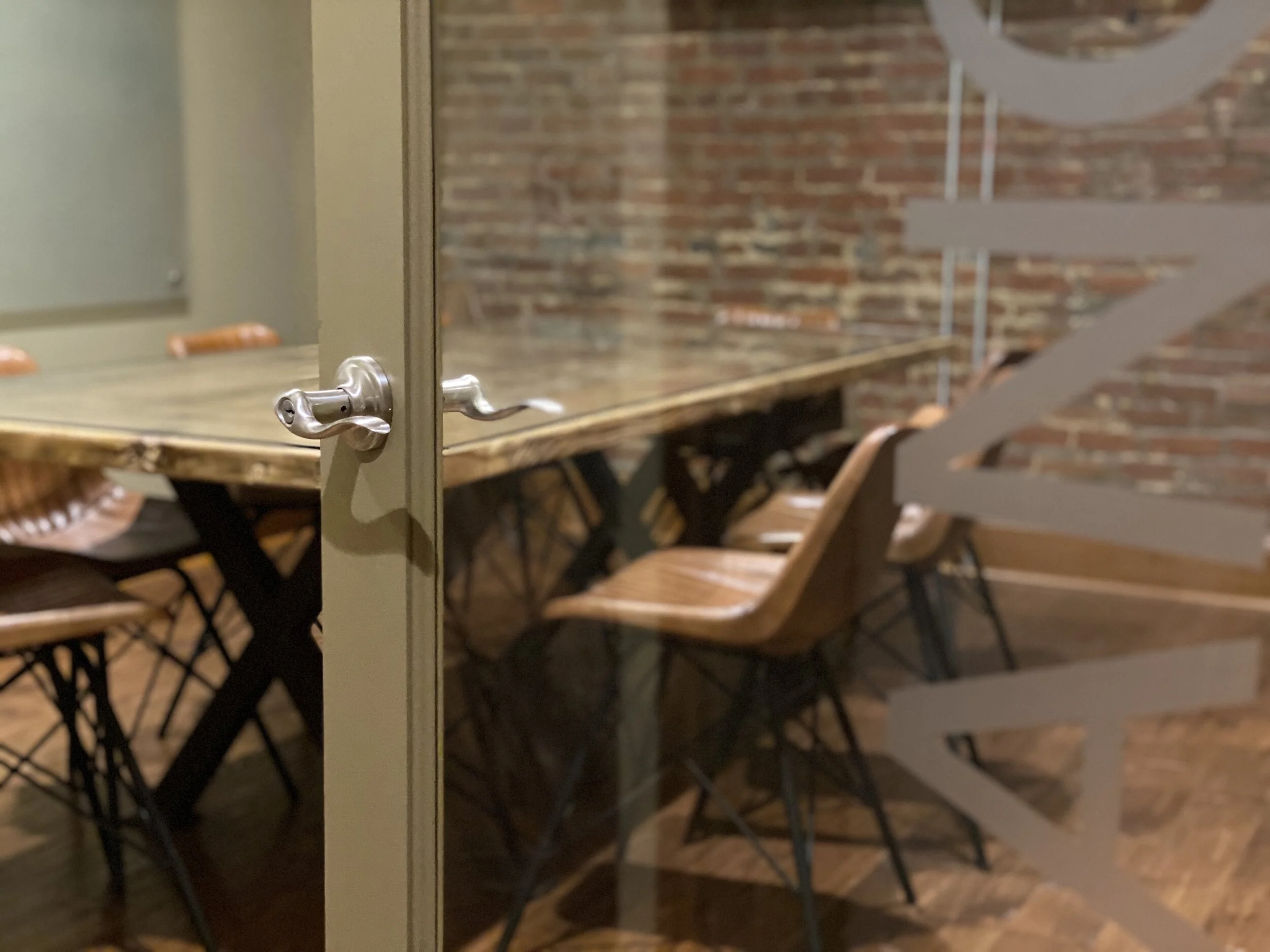 The Mangrove conference room overlooks the coworking floor. Seats 10.